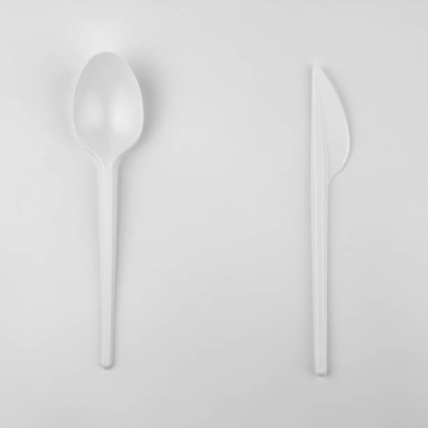 istock clear white plastic spoon and knife on white background, ecological problem, closeup, square photo 1139590698