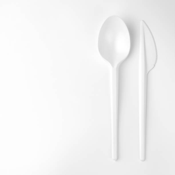 istock clear white plastic spoon and knife on white background with copy space, closeup 1139590926
