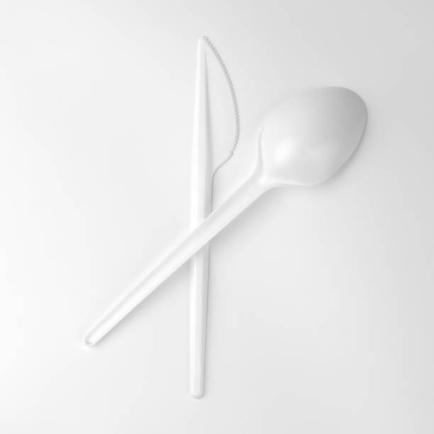 istock clean white plastic spoon lies on knife on white background, ecological problem, closeup, square photo 1139590968