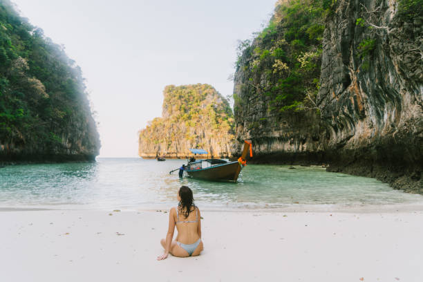 istock Woman sitting on the beach and looking at sea on Koh Phi Phi Island 1139590982