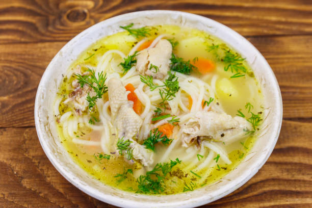 istock Chicken soup with noodles and vegetables on wooden table 1139595183