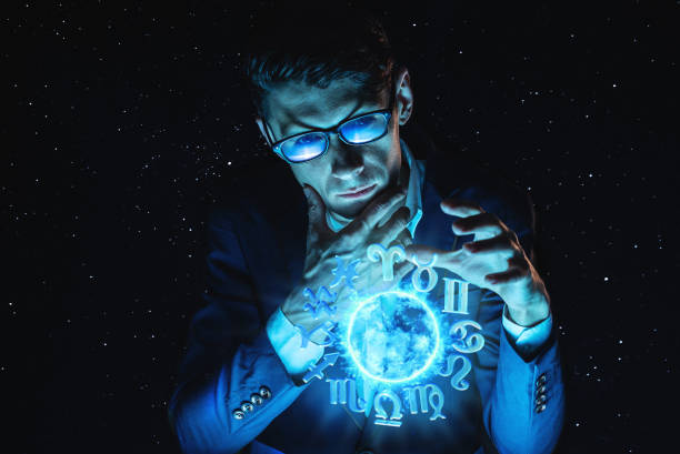 istock Businessman holding hands over the magic sphere with a horoscope to predict the future. Astrology as a business 1139597559