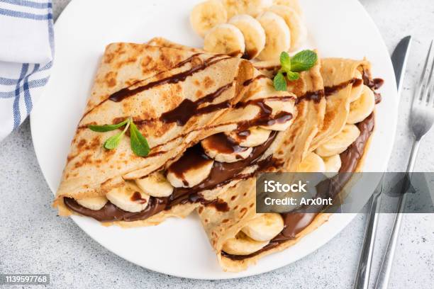 Crepes Or Blini Stuffed With Chocolate Banana Stock Photo - Download Image Now - Crêpe - Pancake, Pancake, Chocolate