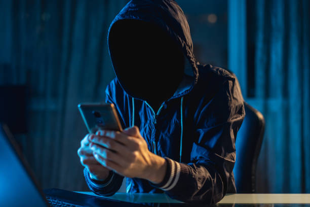 istock Anonymous hacker programmer uses a laptop to hack the system in the dark. Concept of cybercrime and hacking database 1139600300