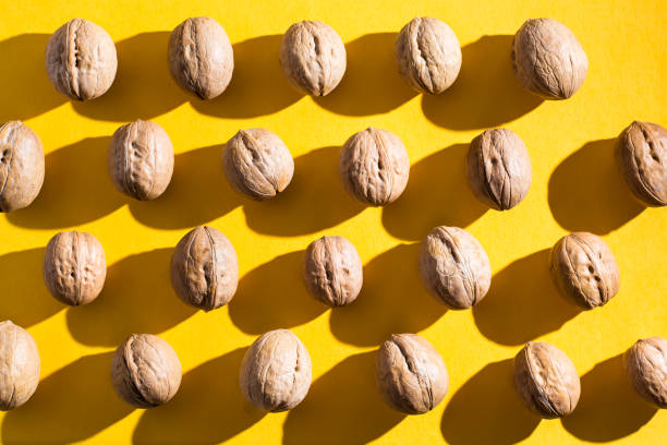 istock Walnuts lie in rows on yellow cardboard 1139600301
