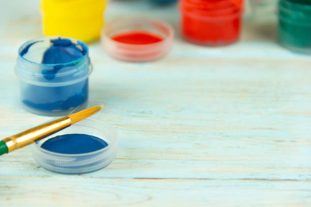 istock Close-up paints and brush on multicolor wooden background with Easter eggs Easter crufts 1139603624