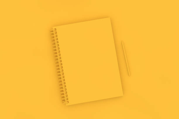 istock Top view of notebook with pencil on yellow background 1139603913