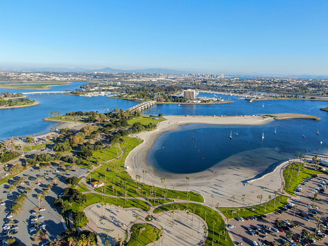 Aerial view of Mission Bay & beaches in San Diego, California, USA. Community built on a sandbar with villas, sea port and recreational Mission Bay Park. Californian beach-lifestyle.