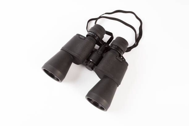 istock Black binoculars with orange lens isolated on white background 1139606787