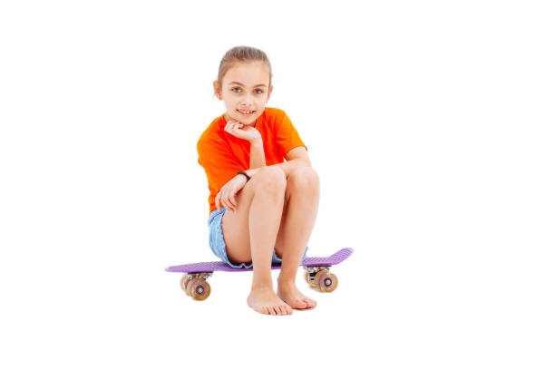 istock Happy girl with skateboard isolated on white in studio 1139607061