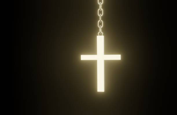 Old Orthodox Church silver cross on a chain lying on the reflecting surface