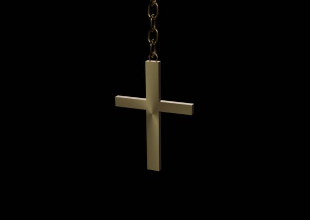 Golden 3D Christian cross on a chain hanging in the dark