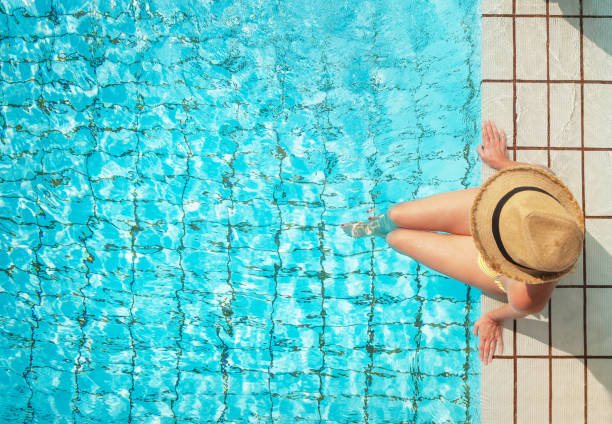 istock Young woman relaxing in swimming pool 1139608076