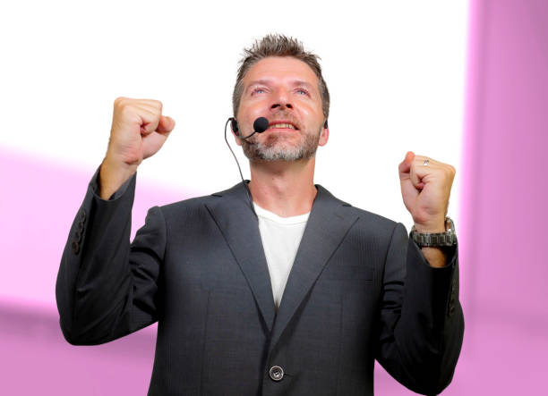 istock young attractive and confident successful man with headset speaking at corporate business coaching and training auditorium conference room talking giving motivation training from speaker stage 1139608097
