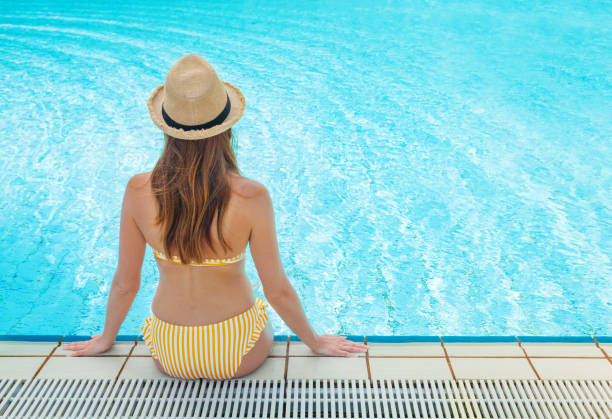 istock Young woman relaxing in swimming pool 1139608682