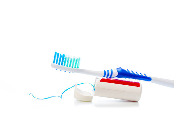 dental floss and toothbrush on an isolated background