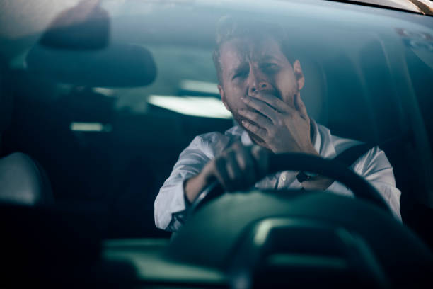 istock Sleepy businessman driving car 1139615358