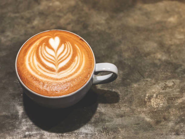 istock Coffee time. latte art coffee cup on the cement  background with vintage cafe light. Copy space and top view 1139615575
