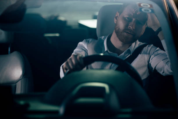 istock Sleepy businessman driving car 1139615593