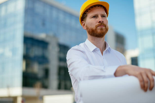 istock Architect with blueprint outdoors 1139615957