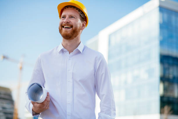 istock Architect with blueprint outdoors 1139615985