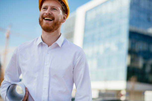 istock Architect with blueprint outdoors 1139616037