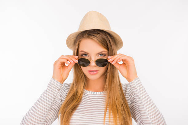 istock girl with a hat putting glasses on her nose 1139616083