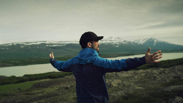 istock Man meditation. Rocky lake coastline 1139617422