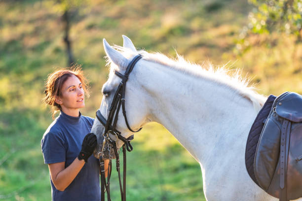 istock Woman holding her mare and looking at it 1139617524