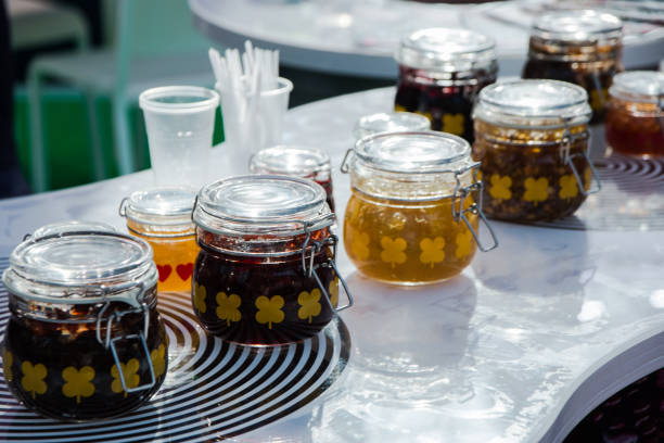 istock glass jars of jam and jelly for tasting on display.Selective focus 1139618459