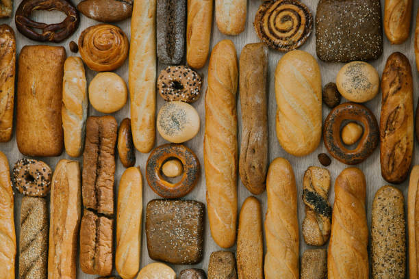 istock different fresh bread on the shelves in bakery. Selective focus 1139618541
