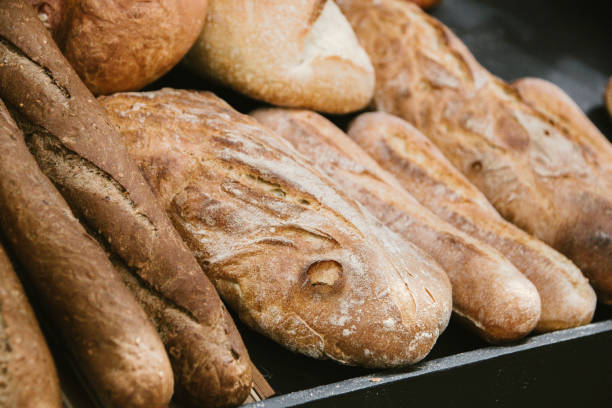 istock different fresh bread on the shelves in bakery. Selective focus 1139618650