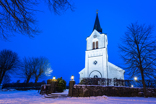 White church in small village of Sweden at night