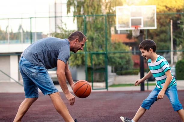 istock Morning Training. Father And Son Playing Basketball 1139621386