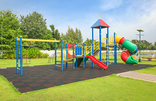 Boy sliding down  in an outdoor play park