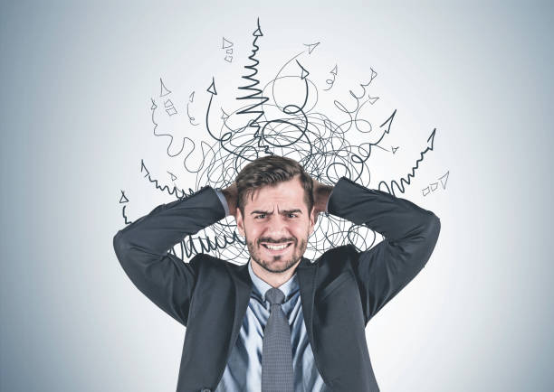 istock Stressed businessman with arrows 1139630448
