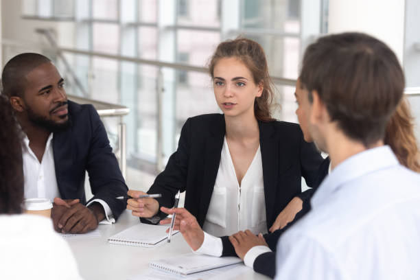 istock Female team leader discussing project plan at group multiracial briefing 1139630464