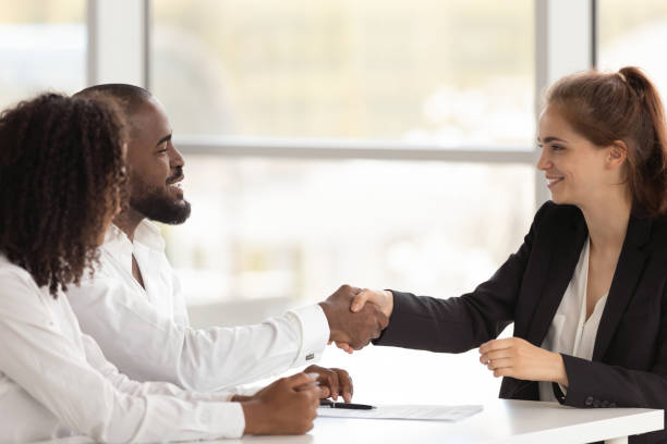 istock Black hr manager handshake with young female applicant starting interview 1139630490