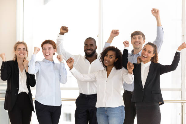 istock Happy diverse employees celebrating victory and success at work 1139630497