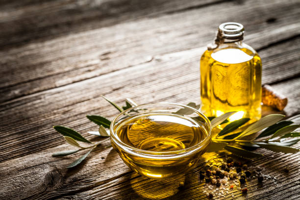 istock Olive oil shot on rustic wooden table with copy space 1139631087