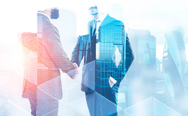 istock Two businessmen shaking hands in city 1139631217