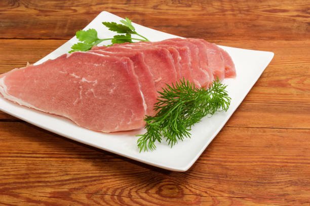 fatias descongeladas uncooked da carne de porco com verdes no prato quadrado - defreeze - fotografias e filmes do acervo
