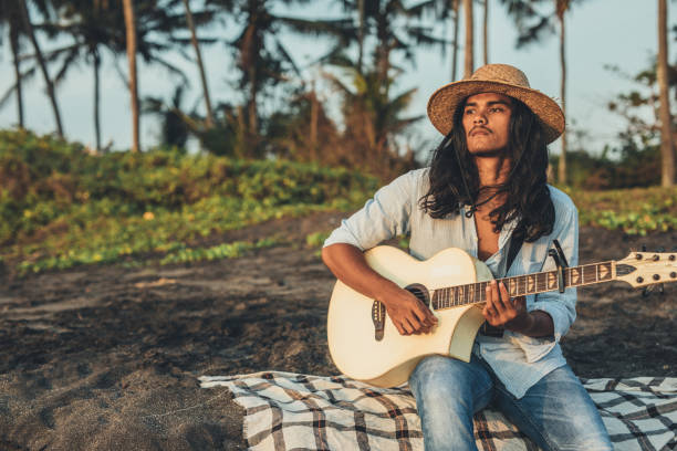 istock Guy playing acoustic guitar in nature 1139633725
