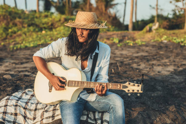 istock Man playing acoustic guitar on the beach 1139635057