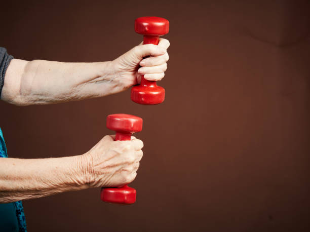 istock Senior hands lifting weights to keep fit in old age 1139639454