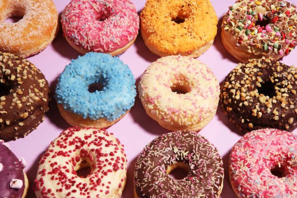 istock assorted donuts with chocolate frosted, pink glazed and sprinkles donuts. 1139647332