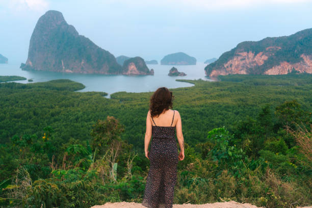 istock Woman standing and   looking at Phang Nga bay 1139649134