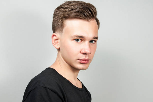 istock White young guy dressed in a black t-shirt on white background looking. 1139649386