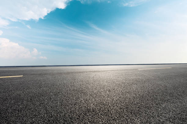 istock Empty asphalt road and blue sky with white clouds 1139650500