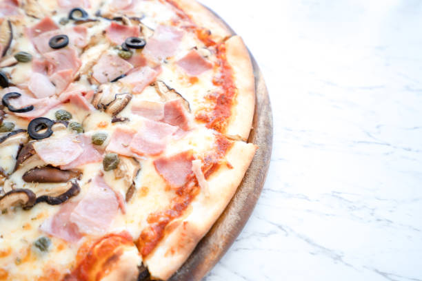 istock Pizza on wooden plate on table 1139652643